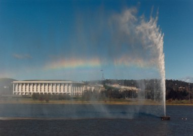 The Captain Cook Fountain making a rainbow
with the National Library in the background